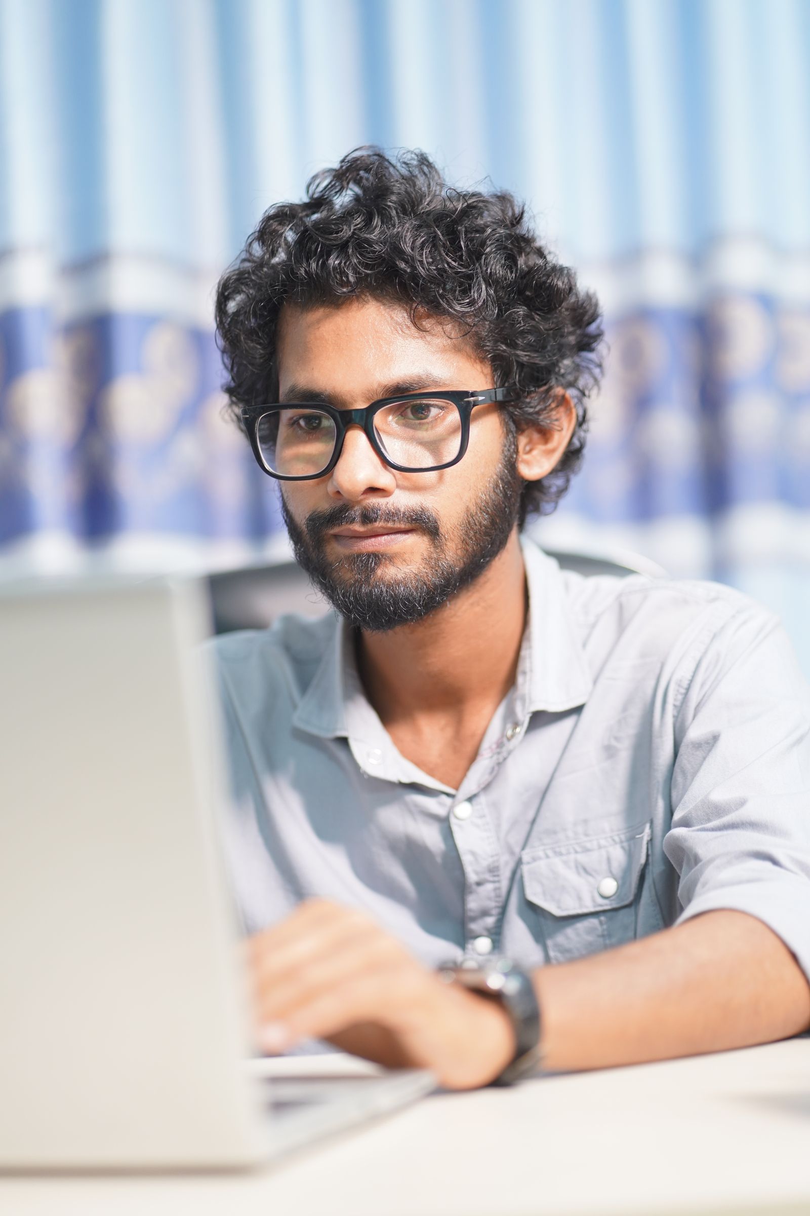 A man working on a laptop.